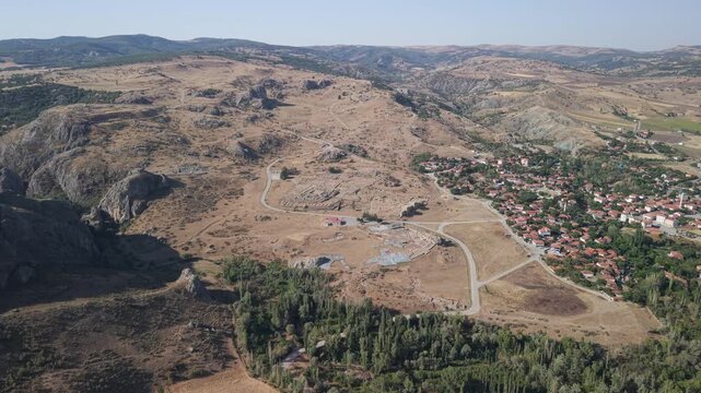 4K 10-bit drone shot flying forward and slowly descending over the ancient ruins of Hattusha, the lost Hittite capital in Turkey