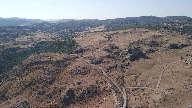 4K 10-bit top-down drone shot flying backward and ascending over the ancient Hittite ruins of Hattusha in Turkey