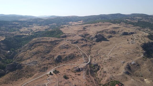 4K 10-bit top-down drone shot flying backward and ascending over the ancient Hittite ruins of Hattusha in Turkey