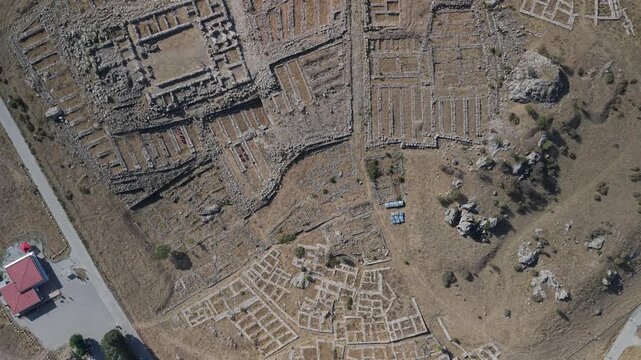 4K 10-bit top-down drone reveal shot ascending vertically to show the ancient Hittite ruins of Hattusha in Turkey