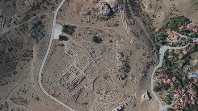 4K 10-bit top-down drone shot flying forward over the ancient ruins of Hattusha Hittite capital in Turkey