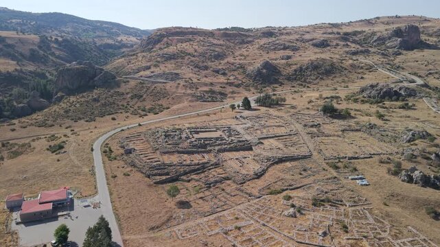 4K 10-bit drone shot flying forward and slowly descending over the ancient ruins of Hattusha, the lost Hittite capital in Turkey