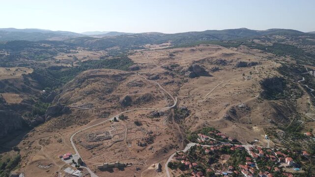 4K 10-bit top-down drone shot flying backward and ascending over the ancient Hittite ruins of Hattusha in Turkey