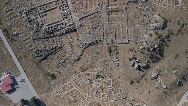 4K 10-bit top-down drone reveal shot ascending vertically to show the ancient Hittite ruins of Hattusha in Turkey