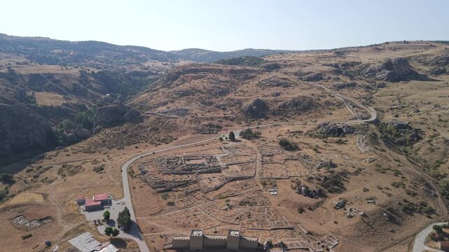 4K 10-bit drone shot flying forward and slowly descending over the ancient ruins of Hattusha, the lost Hittite capital in Turkey