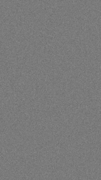 Vertical format retro 16mm film grain texture with dust particles for a vintage cinematic look, seamless loop