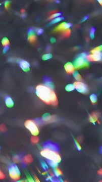 Vertical video. Blur circles. Neon light. Purple orange yellow color lens flare rainbow round texture glisten on abstract bokeh background.