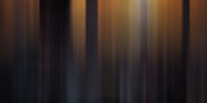 Dark moody background with golden vertical light shafts creating elegant ethereal atmosphere with subtle soft textured gradient.