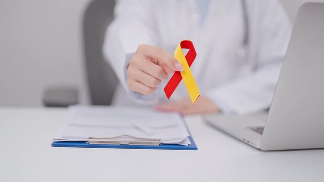 World hepatitis day awareness month, 28 July. Doctor give Red and Yellow ribbon for Liver cancer, Jaundice, Cirrhosis, Failure, Enlarged, Hepatic Encephalopathy and Health concept