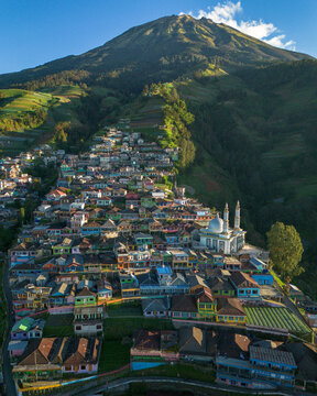 Aerial view of Nepal Van Java, a colorful village on the slopes of Mount Sumbing with terraced fields and a mosque in Kecamatan Kaliangkrik, Jawa Tengah, Indonesia.
