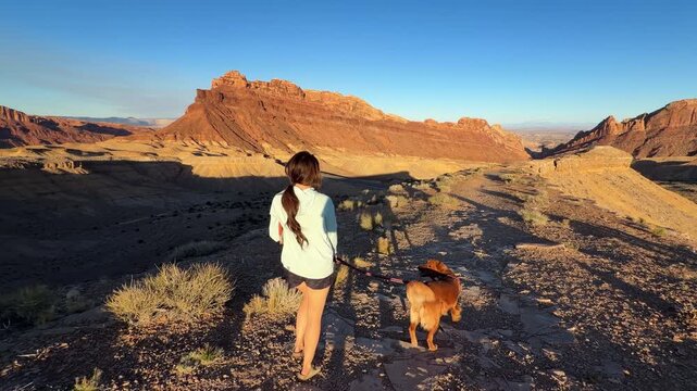 Woman With Dog Walking on Trail in Spotted Wolf Canyon, San Rafael Swell Utah USA