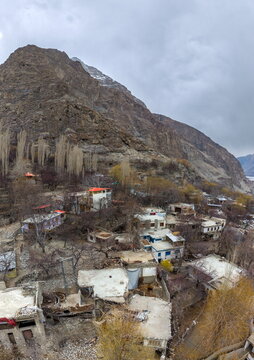 Aerial view of Khaplu valley featuring traditional stone houses with flat roofs nestled against the rugged mountain slopes of the Karakoram range in Khaplu, Gilgit Baltistan, Pakistan.