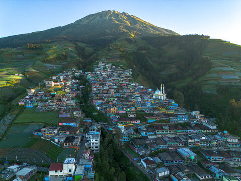 Aerial view of Nepal Van Java, a colorful village on the slopes of Mount Sumbing with terraced fields and a mosque in Kecamatan Kaliangkrik, Jawa Tengah, Indonesia.