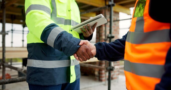 Men, shaking hands and tablet on construction site for agreement, development deal and welcome. Engineer, team and handshake with tech for partnership and renovation collaboration at scaffolding