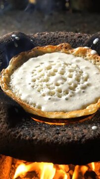 Traditional Indonesian Serabi Pancake Cooking on Open Wood Fire