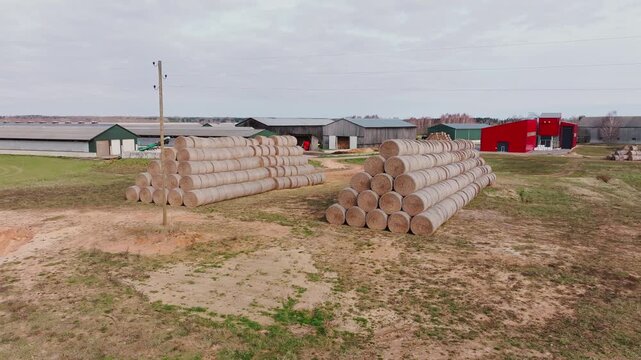 Orderly rows of harvested fodder bales reflect modern farming in Kurzeme