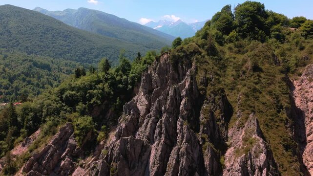 Sharp rocky dolomites ridges framed by steep green hillsides near Lago di Barcis, Italy. Dramatic mountain
