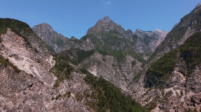 Deep alpine valley leading towards the sharp peaks of Friulian Dolomites. Idyllic nature scenery.
