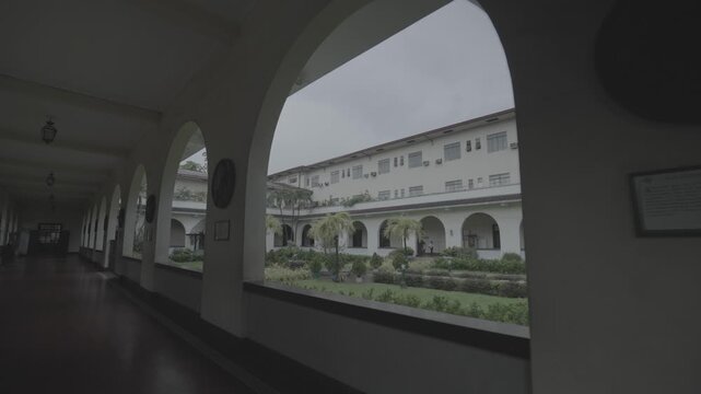 4K S-Log smooth glide shot of the garden and exterior grounds of Sto. Domingo Church in Quezon City, Philippines, showcasing landscaped greenery and peaceful church surroundings.