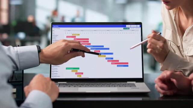 Project Manager Leads Diverse Team Reviewing Gantt Chart Schedule