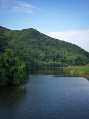 Fototapeta premium Beautiful Scenery of Green Hills and Clear Waters at Cao'e River Scenic Area in Shaoxing