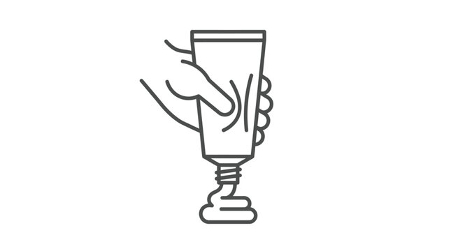 Hand squeezing lotion from plastic tube.