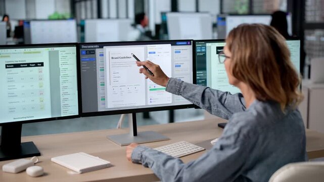 Mature Woman Using Computer Screens
