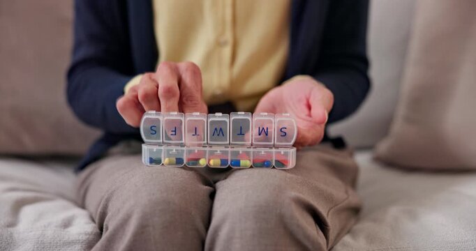 Retirement, pills and hands in house with box, treatment plan and sorting of daily dose. Wellness, medication or old woman with container, prescription organizer or drug routine in health management.