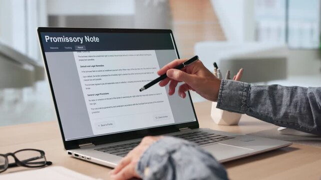 Woman Reviews Loan Agreement Terms On Laptop