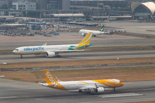 Aerial view of a Cebu Pacific Airbus A330-900 and a Scoot Airbus A321 at Bangkok's Suvarnabhumi Airport - Bangkok, Thailand