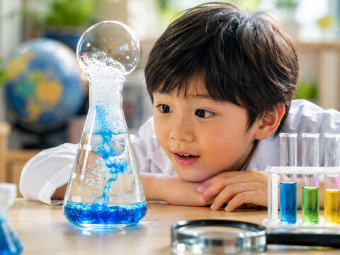 Curious Child Observing a Science Experiment with Laboratory Glassware