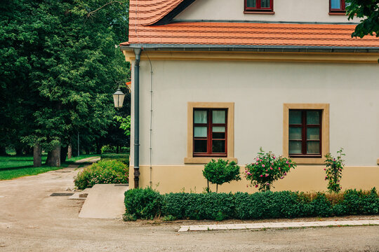 Corner of 19th century house in summer park, Europe, historic architecture, greenery