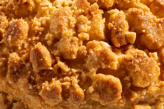 High-Resolution close-up of golden peanut crumble topping ultra sharp macro and extreme detail of crunchy streusel texture full frame