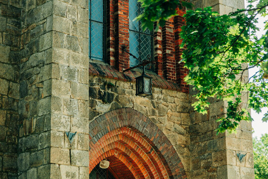 Lantern at entrance arch of 19th century Catholic Christian church, Europe.