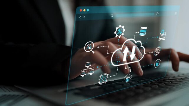 Business professional using laptop with digital cloud computing icons and graphs illustrating data transfer and technology connection in modern workspace. Entropy.