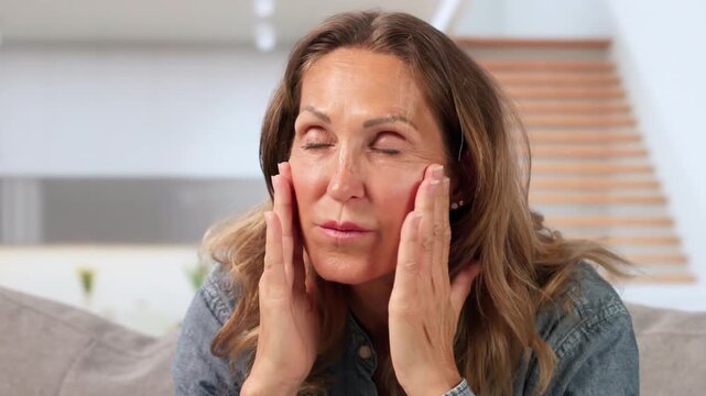 Older Woman Sitting Quietly At Home, Feeling Dizzy