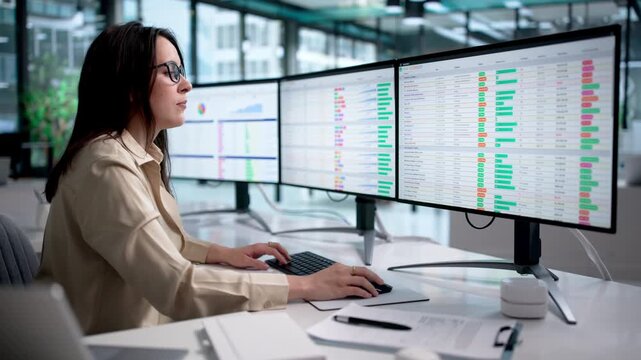 Medical Billing Coder Reviewing Spreadsheet Data On Computer