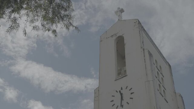 4K S-Log static shot of the clock tower on Sto. Domingo Church in Quezon City, Philippines, highlighting the church&rsquo;s iconic upper structure and architectural details in a clear exterior view.