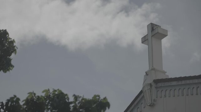 4K S-Log static shot of the cross on top of Sto. Domingo Church in Quezon City, Philippines, highlighting the iconic religious symbol and church rooftop architectural detail.