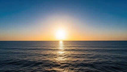 Obraz premium Golden sunset sun reflecting over calm deep blue ocean.