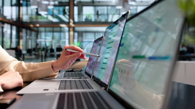 Project Manager Reviewing Timesheets On Laptop