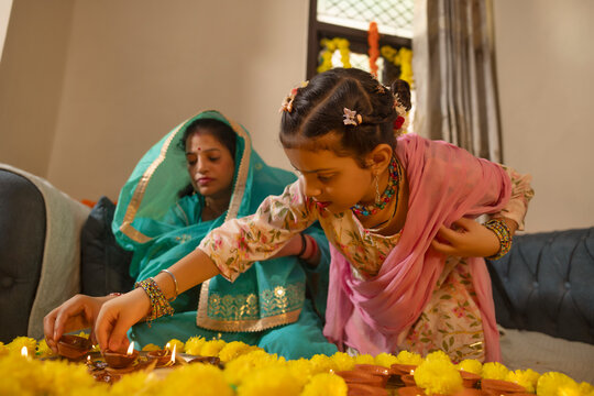 Child lighting traditional lamps during a festive celebration