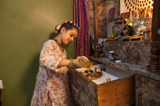 Young girl preparing for a traditional ritual at home