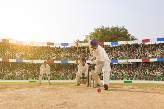 Female cricketer preparing to hit the ball