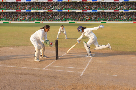 Batsman narrowly escaping a run-out in a cricket match
