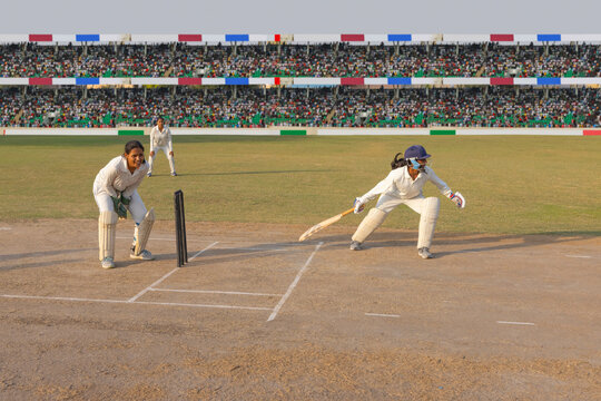 Batsman attempting a run during a cricket match