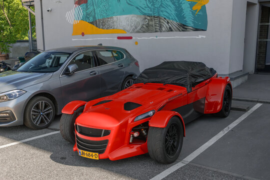 Laxou, France - May 23rd 2026 : View on an orange Donkervoort Premium D8 GTO with black rims parked on a street.