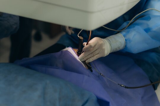 Surgeon performing delicate medical procedure using modern equipment