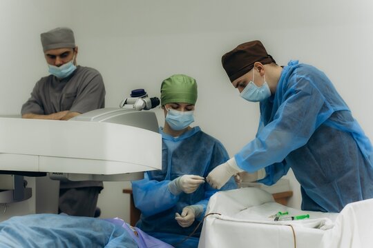 Medical team performing laser eye surgery operation
