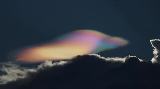 Iridescent cloud dark sky colorful cloud atmospheric phenomenon dramatic nature evening rare glowing mysterious peaceful cloudscape weather sky light spectrum reflection surreal tranquil outdoor